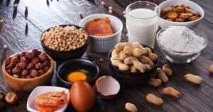 from left to right - hazelnuts, shrimp, soy beans, eggs, fish, peanuts, milk, flour, seafood