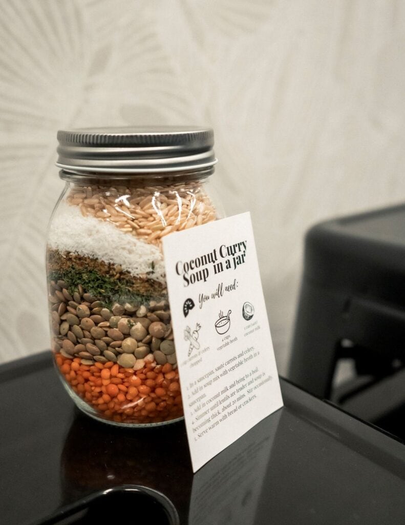 red and green lentils, shredded coconut and brown rice placed in jar with gift tag