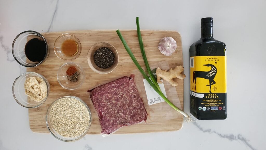ingredients for the beef quinoa bowl spread on a cutting bowl