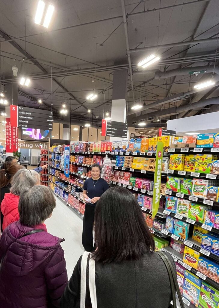 dietitian leading a group in a grocery tour, looking at snack options